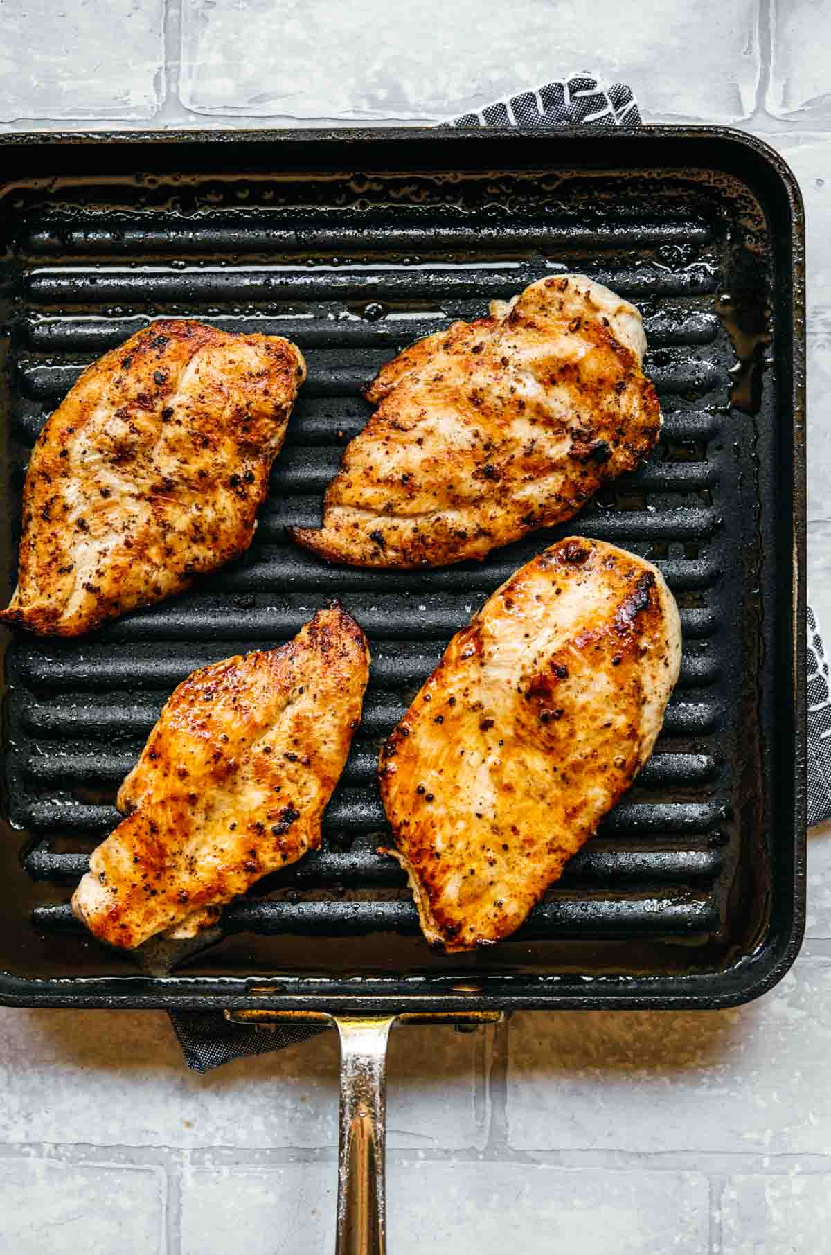 Grilled chicken breasts on pan for Grilled Chicken Sandwich