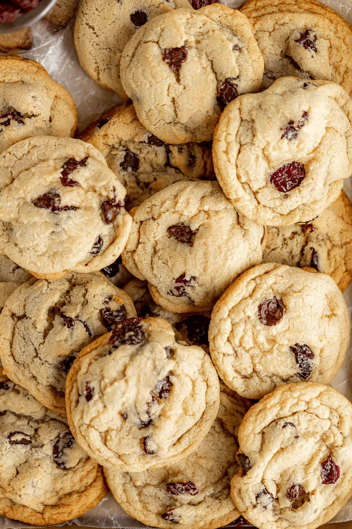 Several cookies with cherry chunks overlapping each other