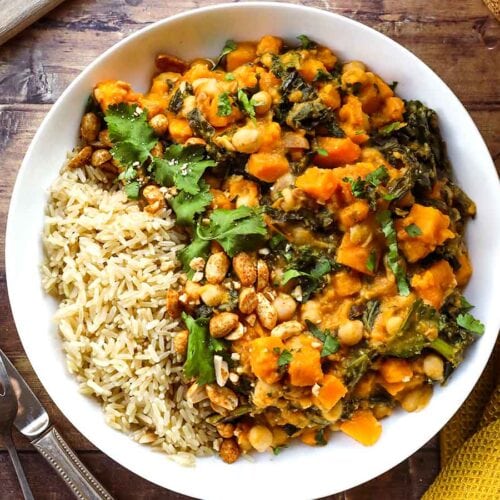 stew being served along rice in a bowl