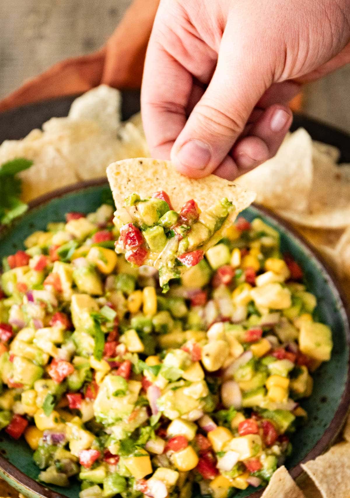 Avocado Salsa in serving bowl with tortilla chips