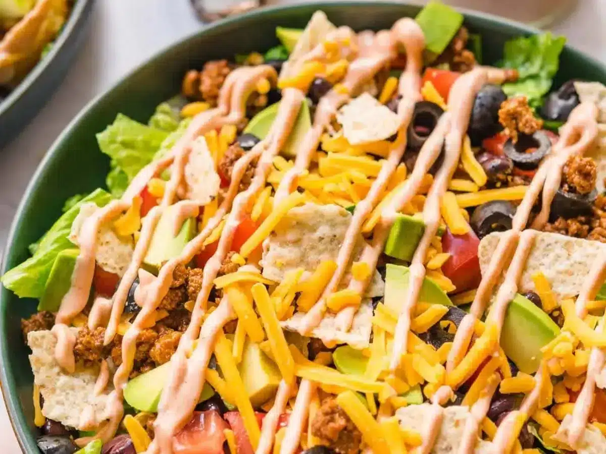 salad with chips and beef topped with dressing