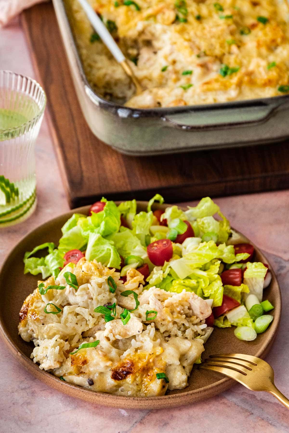 Chicken and Rice Casserole on dinner plate with salad
