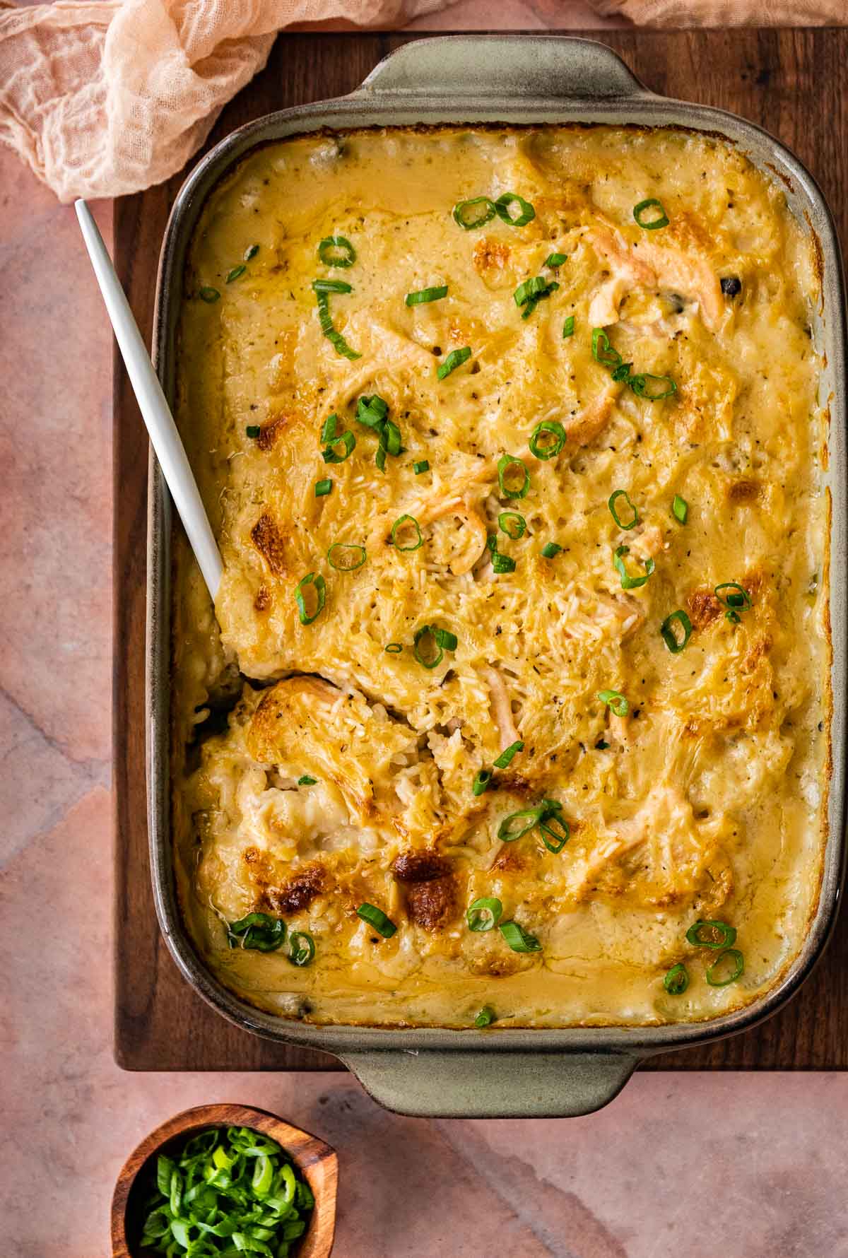 Chicken and Rice Casserole in baking dish after baking with serving spoon