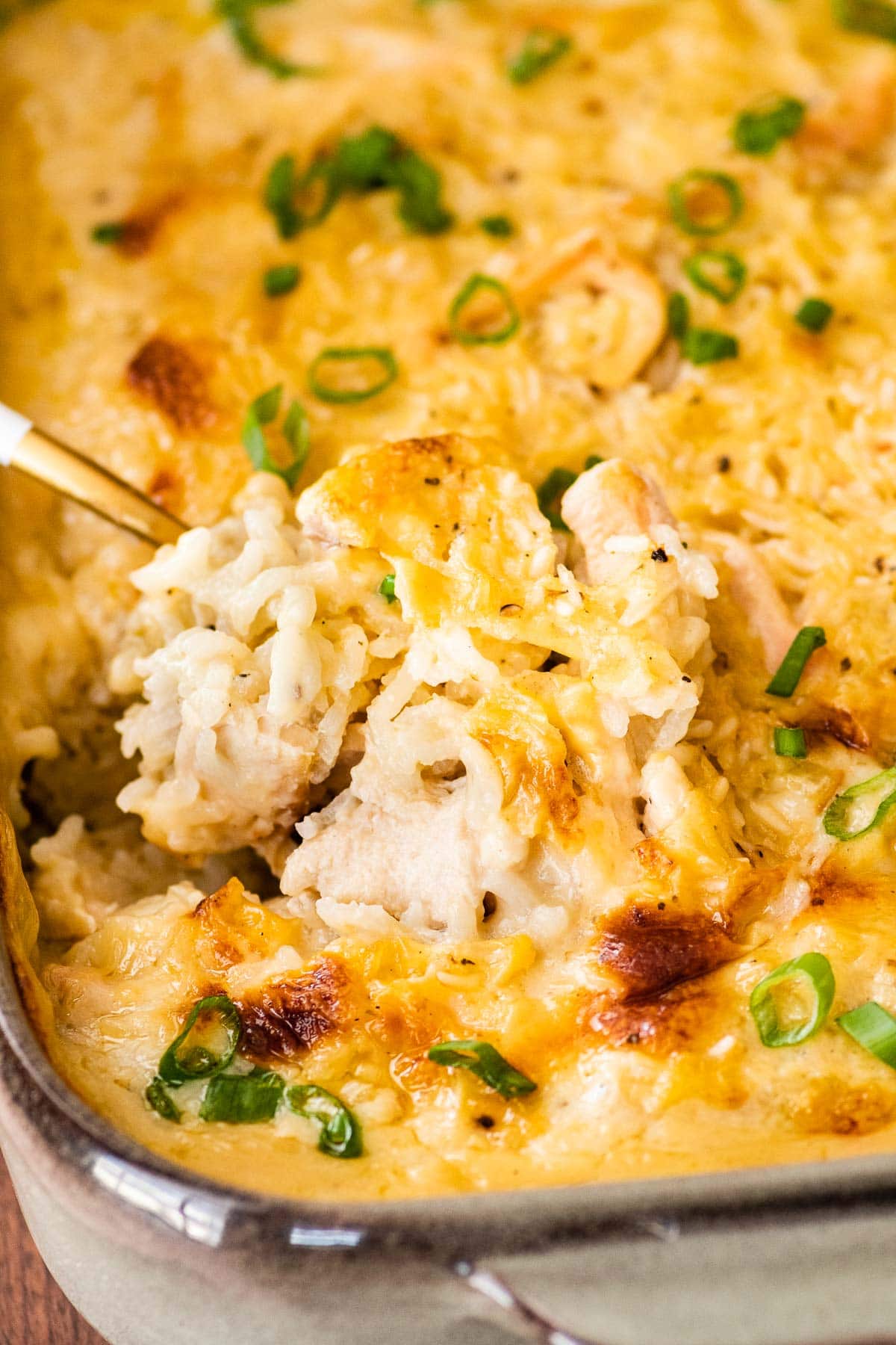 Chicken and Rice Casserole in baking dish after baking with serving spoon