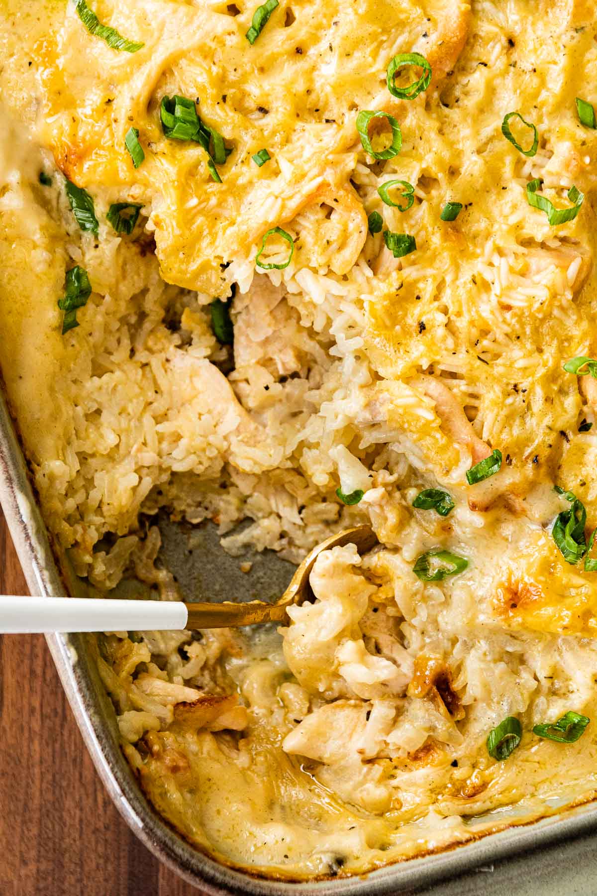Chicken and Rice Casserole in baking dish after baking with serving spoon