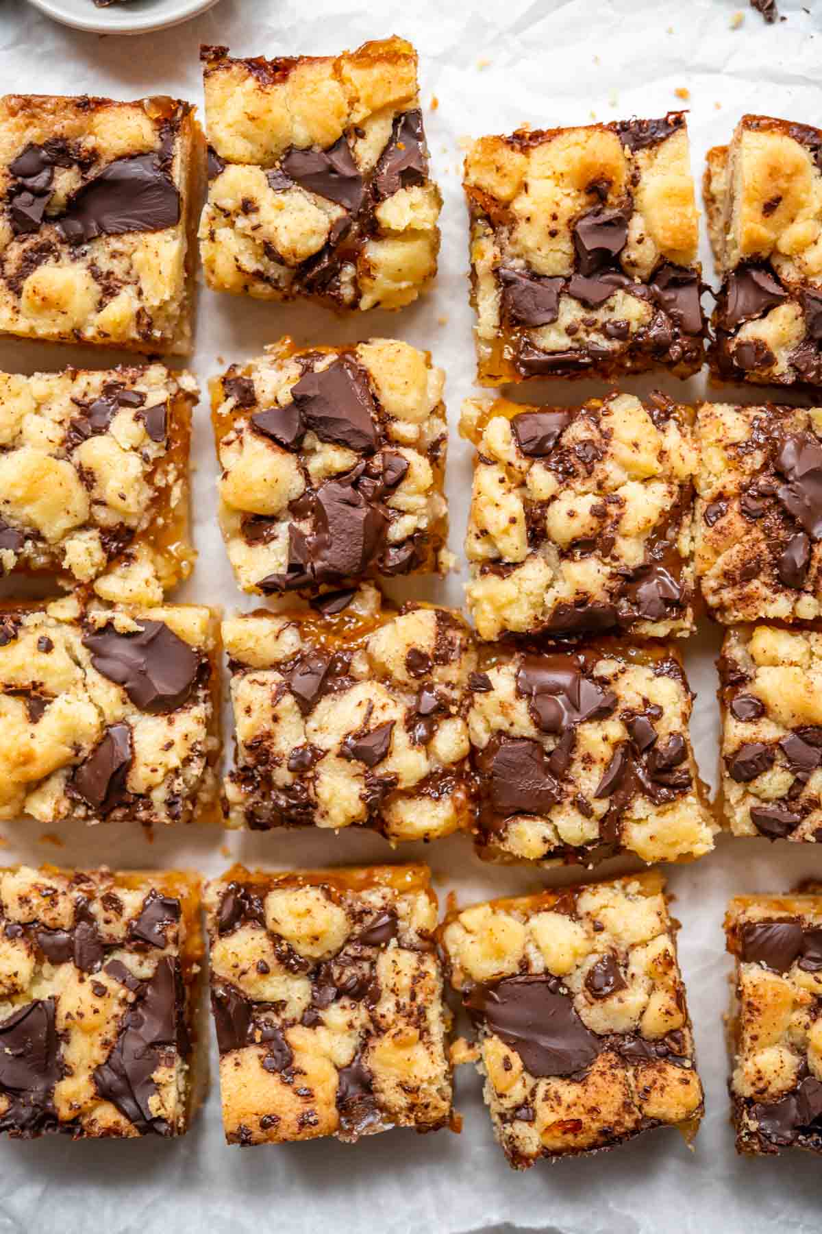 Sliced Dark Chocolate Orange Shortbread Bars on parchment