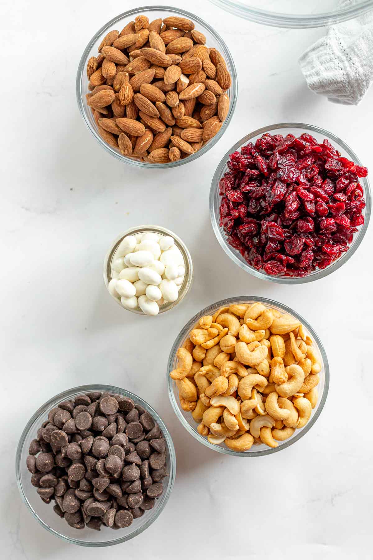 Cranberry Trail Mix ingredients in separate glass bowls