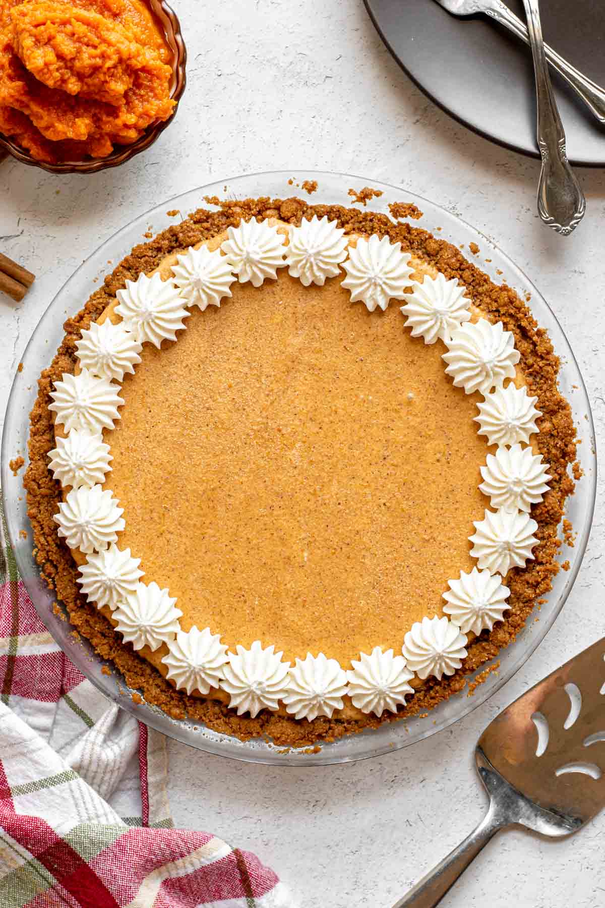 Frozen Pumpkin Ice Cream Pie finished with whip cream stars around crust edge