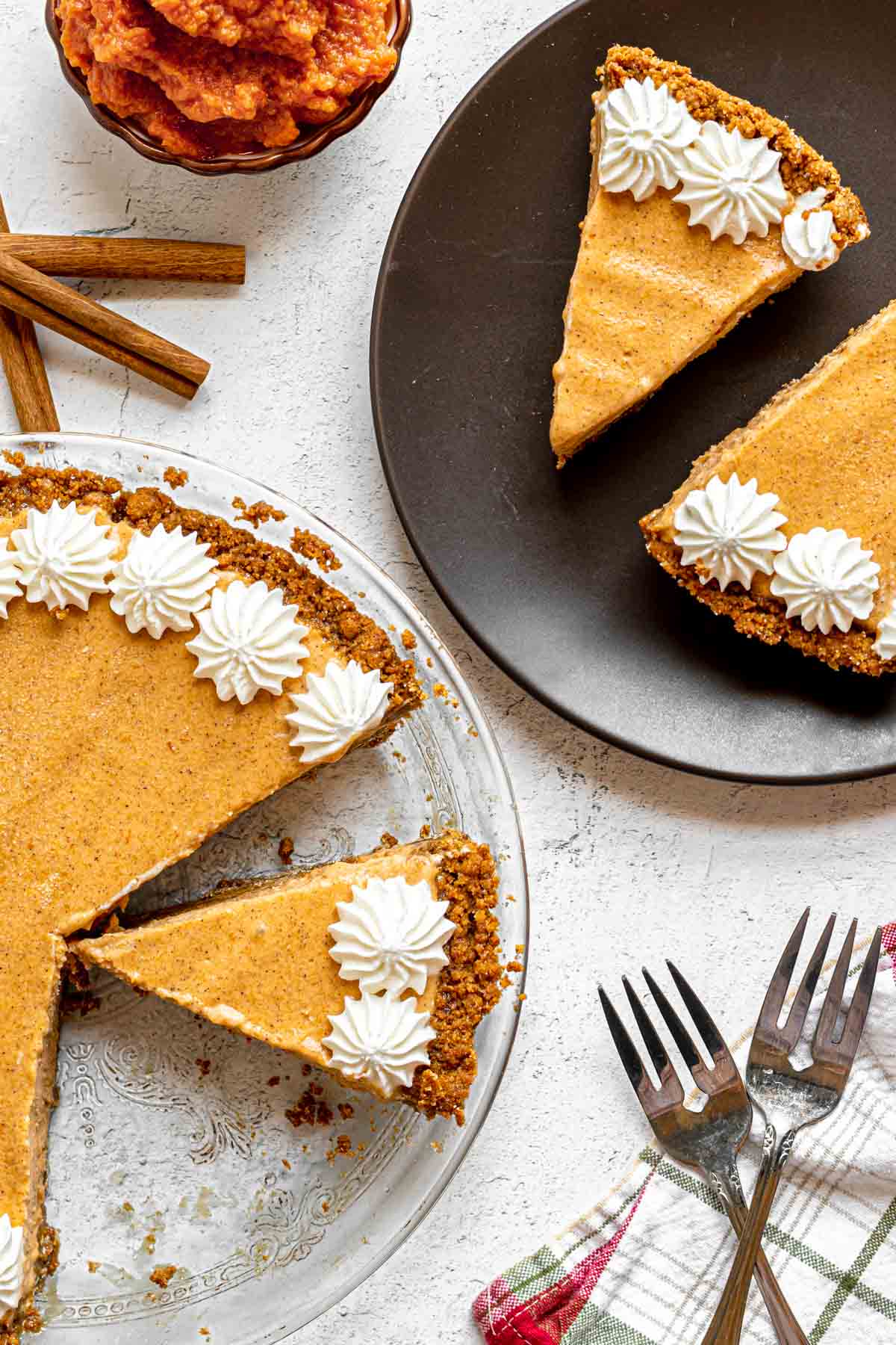 Frozen Pumpkin Ice Cream Pie with whip cream starts around crust edge, sliced in pie plate