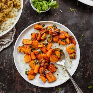 Indian Spiced Honey Roasted Carrots on serving plate with spoon