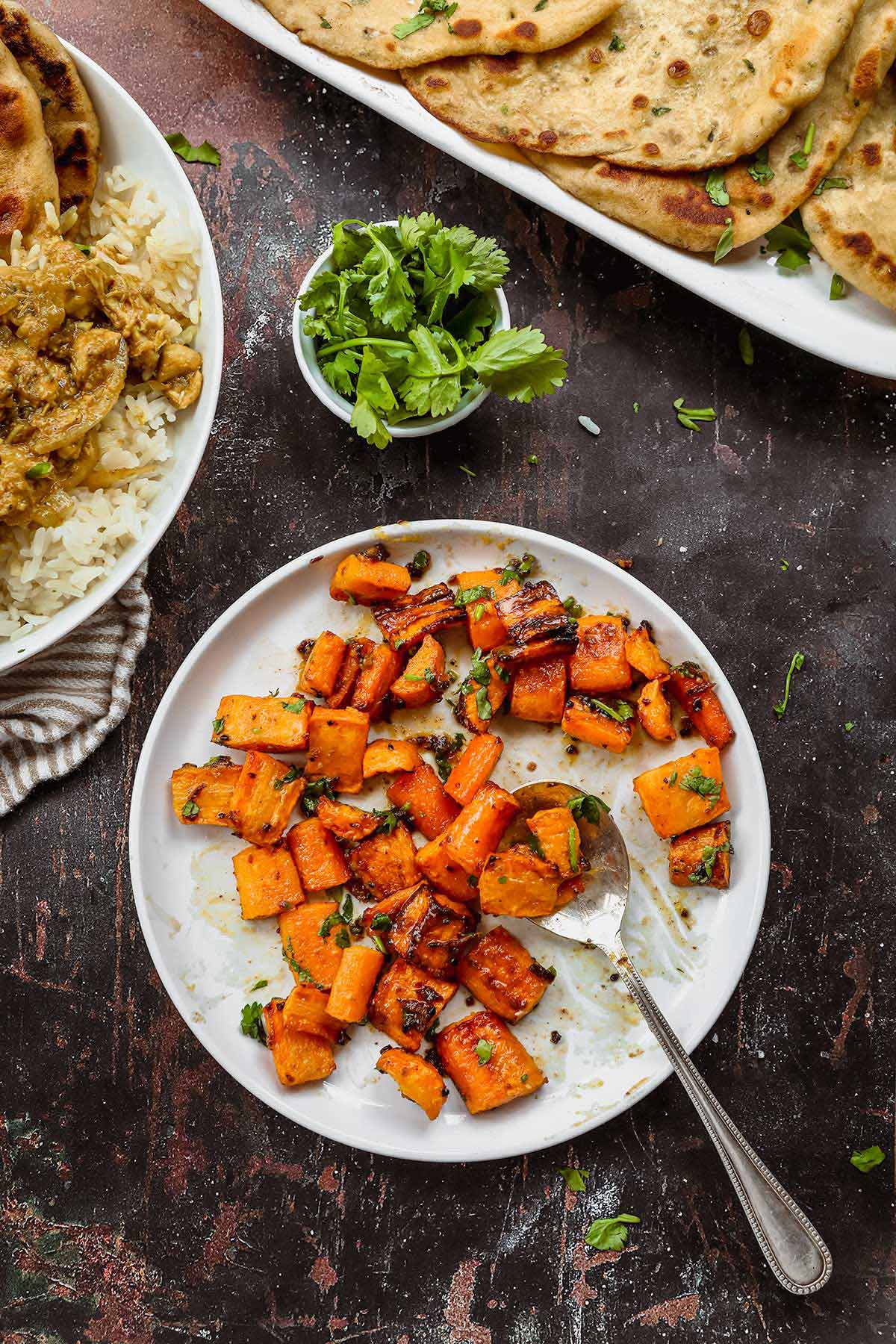 Indian Spiced Honey Roasted Carrots on serving plate with spoon