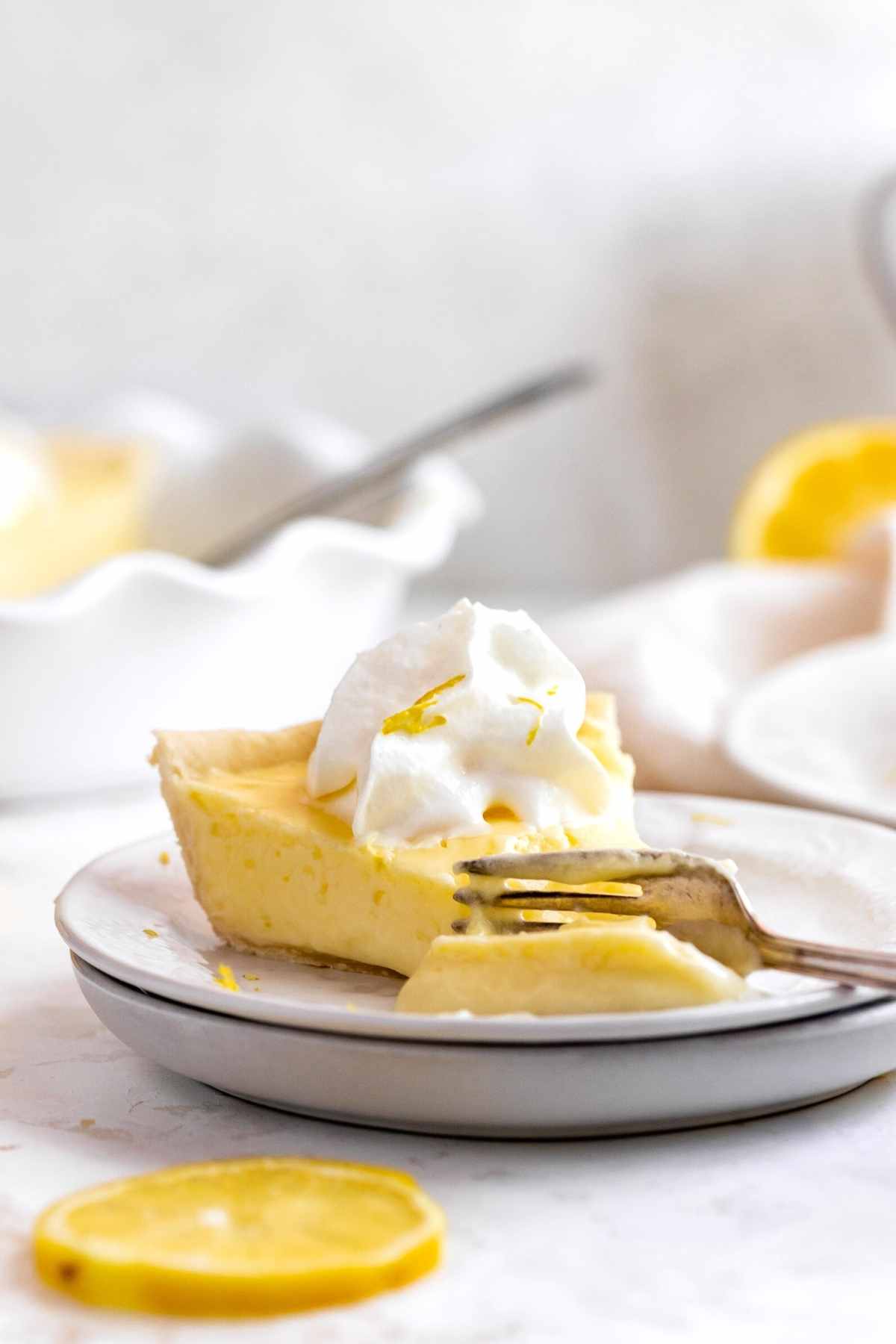 Lemon Chiffon Pie slice on plate with fork