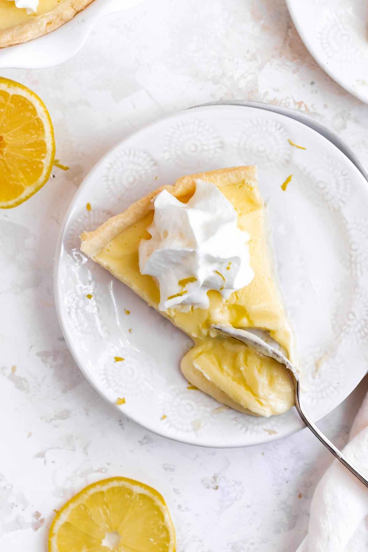 Lemon Chiffon Pie slice on plate with fork