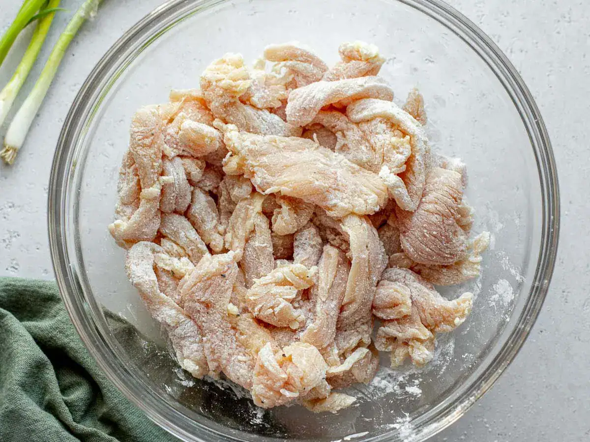 Pieces of poultry coated in seasonings and cornstarch.