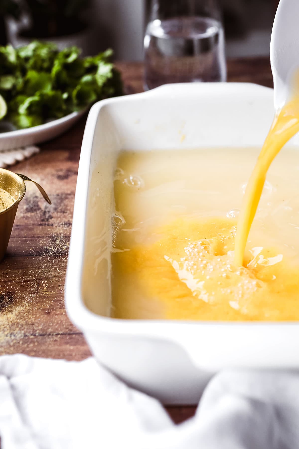 Baked Creamy Polenta liquid added to dry polenta in baking dish