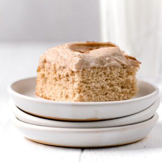 Snickerdoodle Sheet Cake with cinnamon buttercream and cinnamon dusted on top sliced on plate