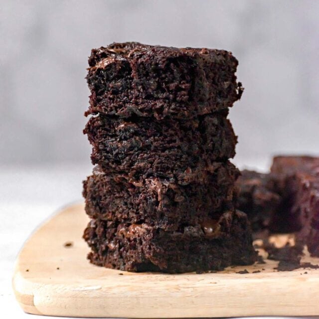 Sliced Zucchini Brownies in stackstacked on cutting board