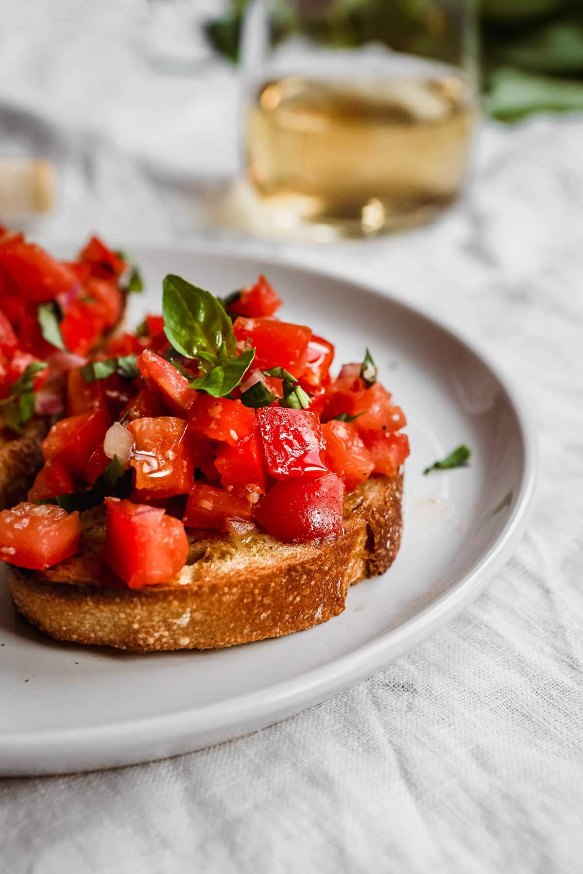 Balsamic Bruschetta tomato mixture on toasted bread on plate