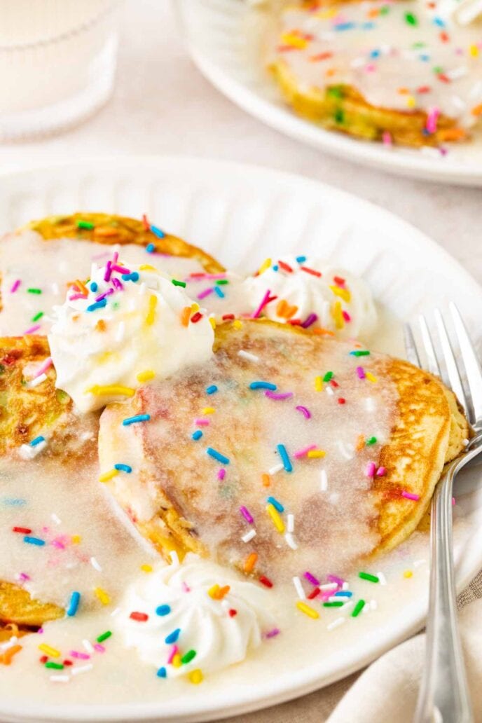 Birthday Cake Pancakes on plate with vanilla glaze