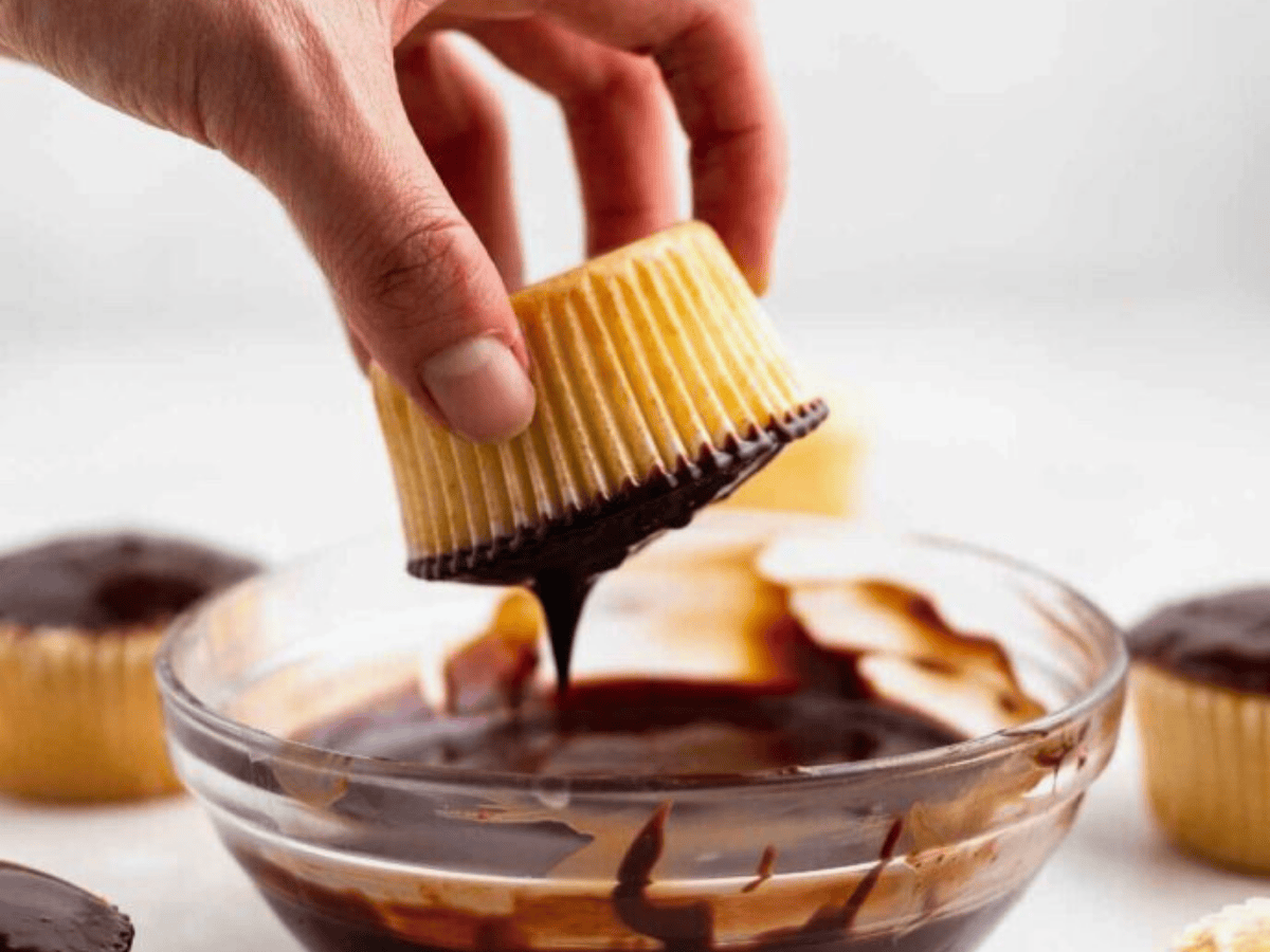dipping cupcake in chocolate in bowl