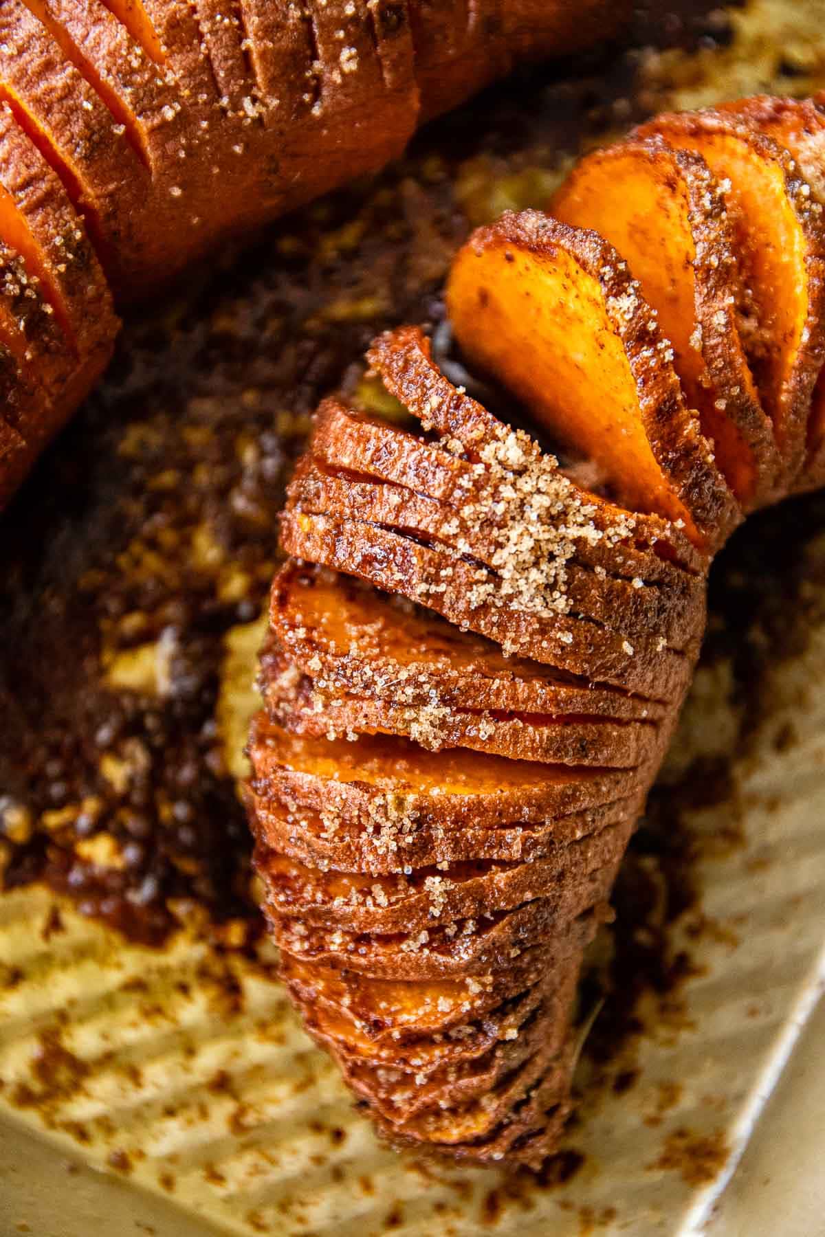 Candied Hasselback Sweet Potatoes on baking sheet closeup