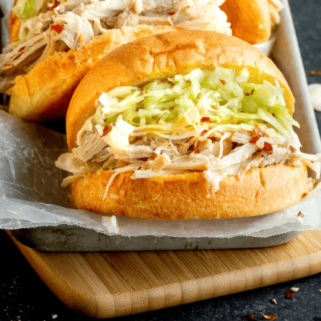 Close up of chicken on bun with veggies