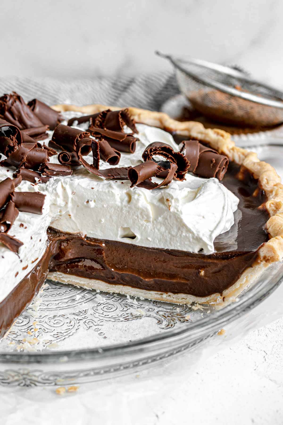 Chocolate Cream Pie with whipped cream and chocolate shavings in pie dish