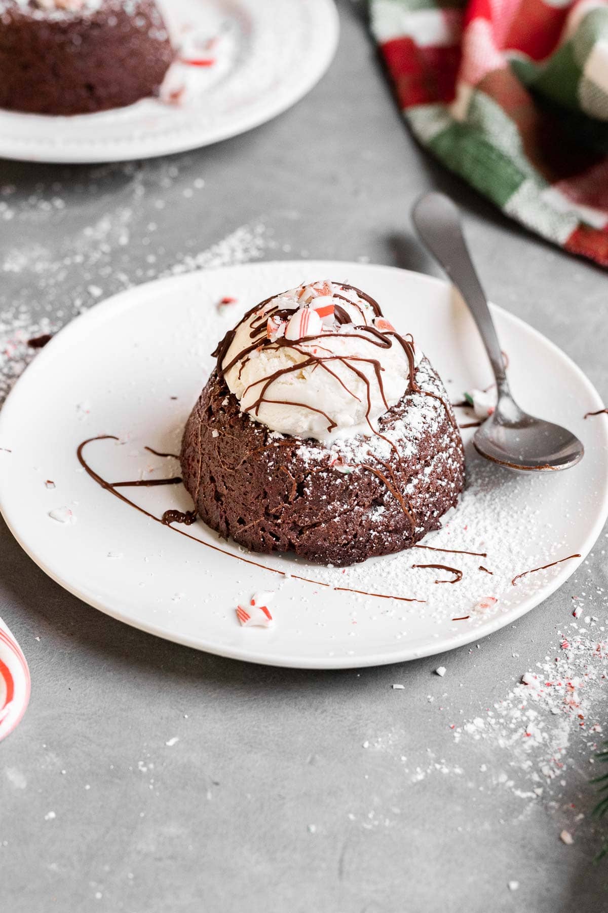 Chocolate Peppermint Lava Cakes served with vanilla ice cream on plate with spoon