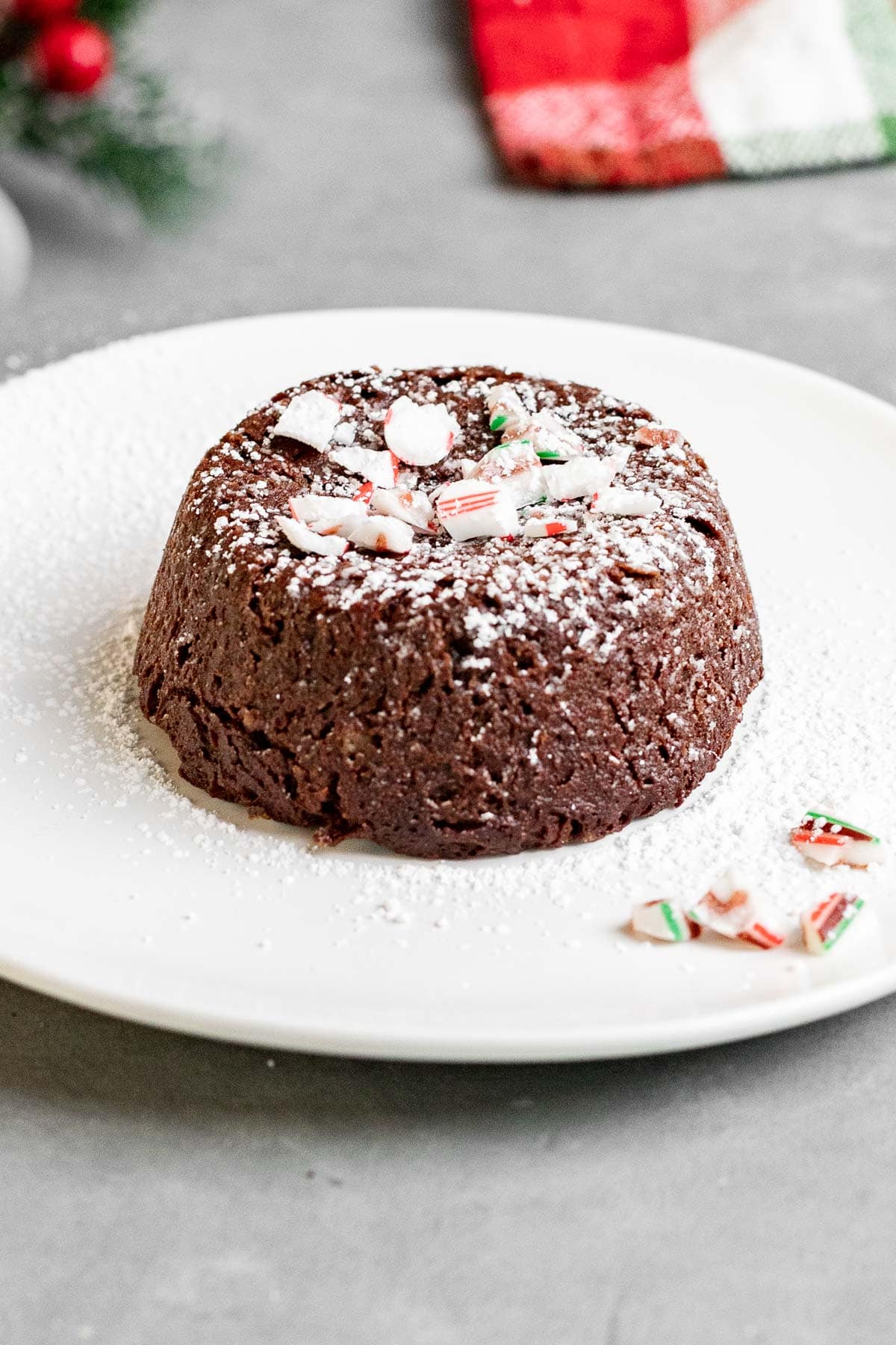 Chocolate Peppermint Lava Cakes dusted with powdered sugar and garnished with crushed peppermint candy