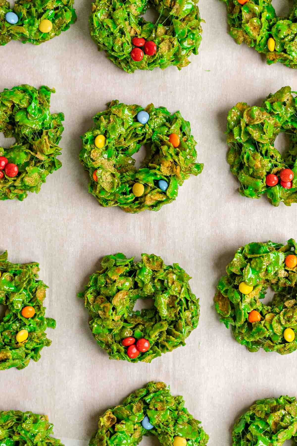 Christmas Wreath Cookies displayed on white parchment paper.