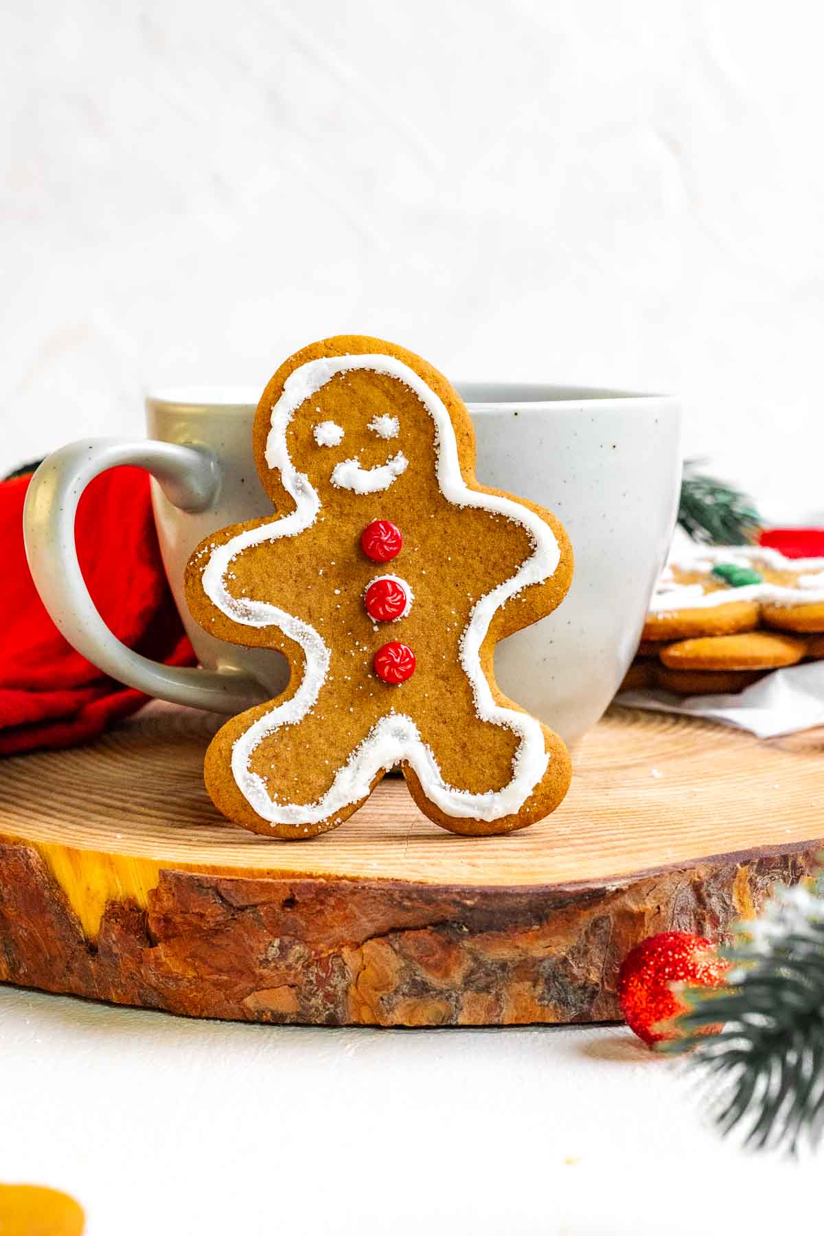 Gingerbread Man Cookie served with a mug of hot chocolate on a wooden tray.