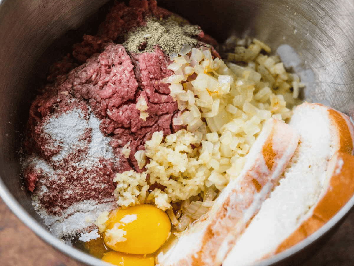 ground beef, eggs, bread, garlic, salt, and pepper in a mixing bowl