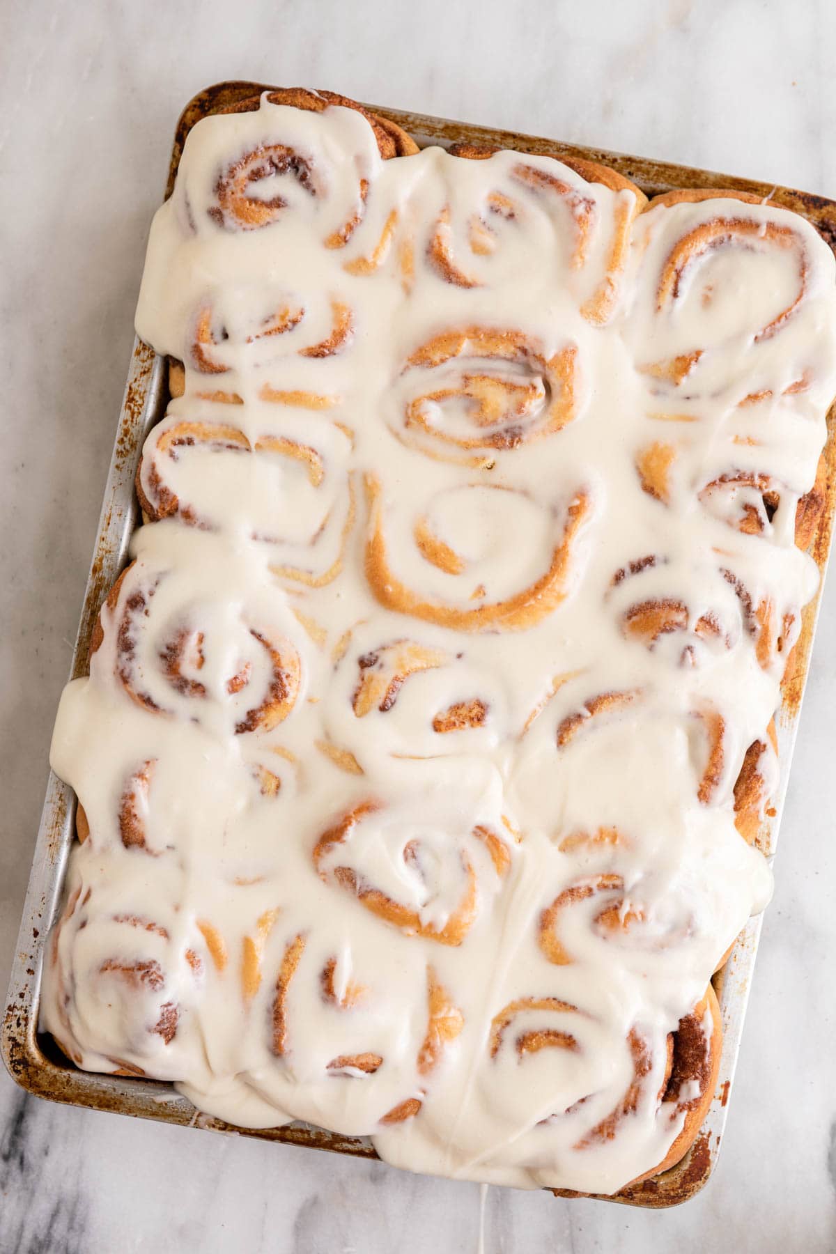Maple Cinnamon Rolls with icing in baking dish