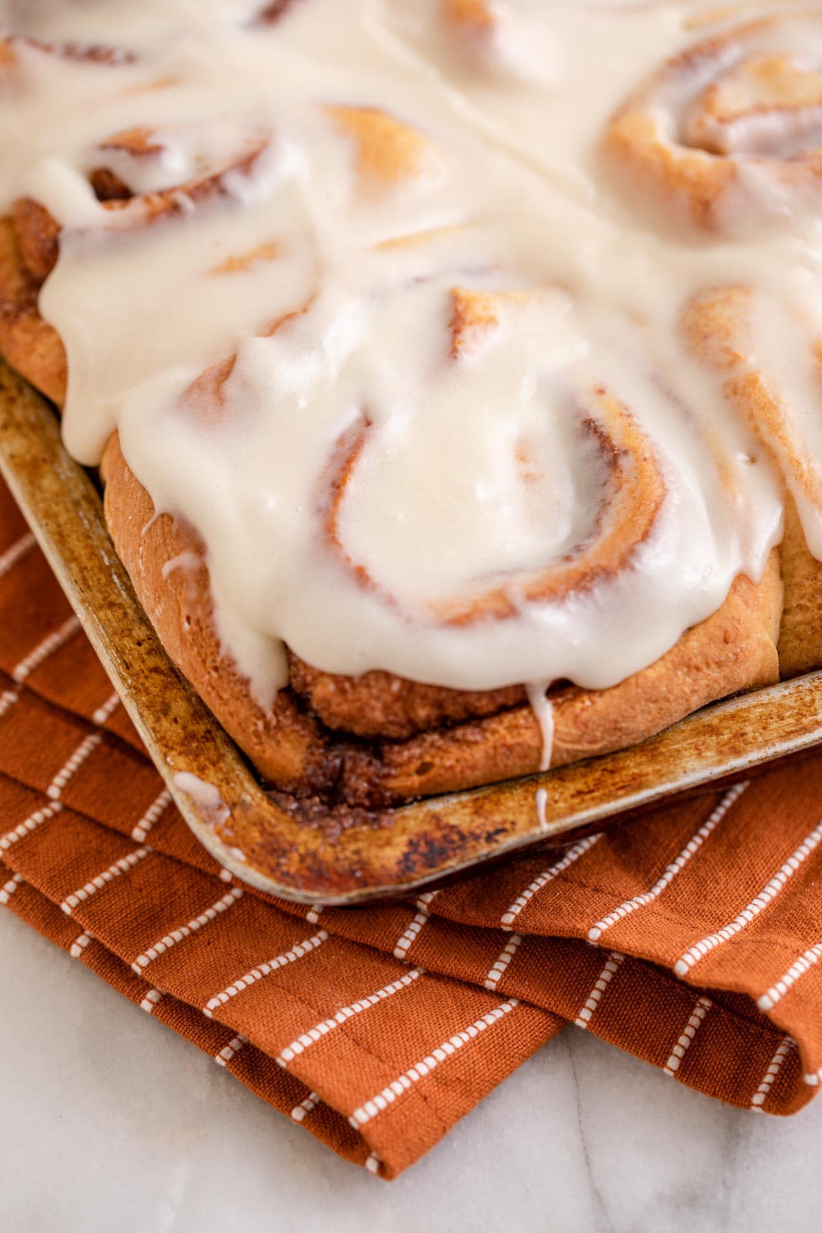 Maple Cinnamon Rolls with icing in baking dish