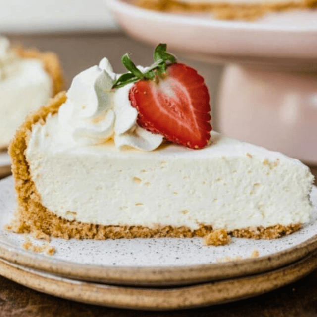 Side view of cheesecake slice with strawberry