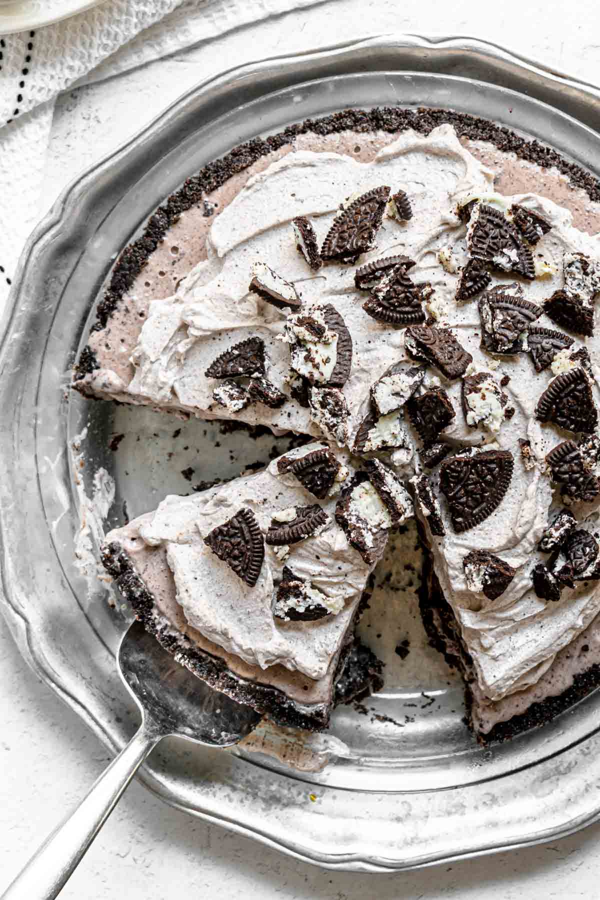 Oreo Ice Cream Pie garnished with whipped cream and oreo pieces