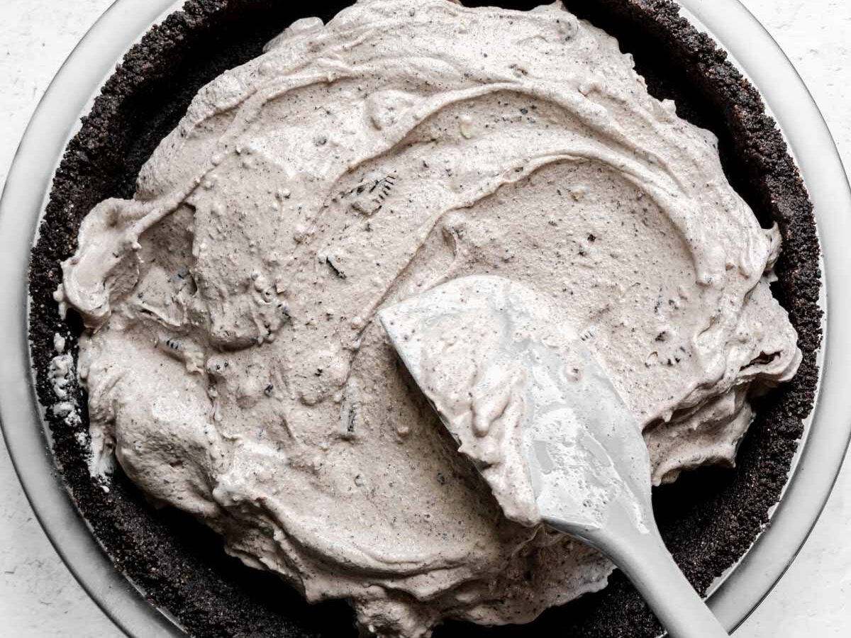 Oreo Ice Cream Pie filling spread into crust