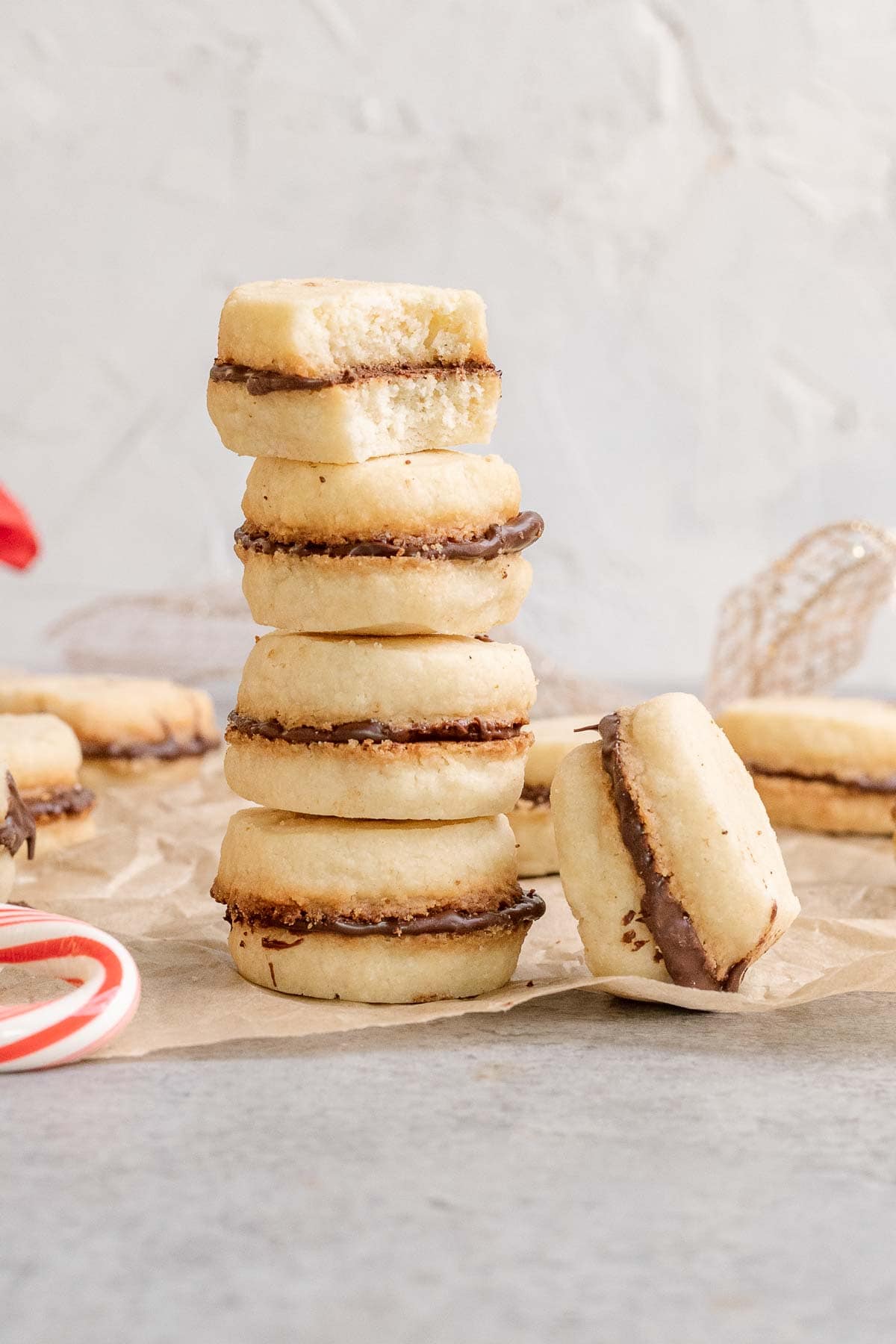 Peppermint Sandwich Cookies baked and filled in stack with bite out of top cookie