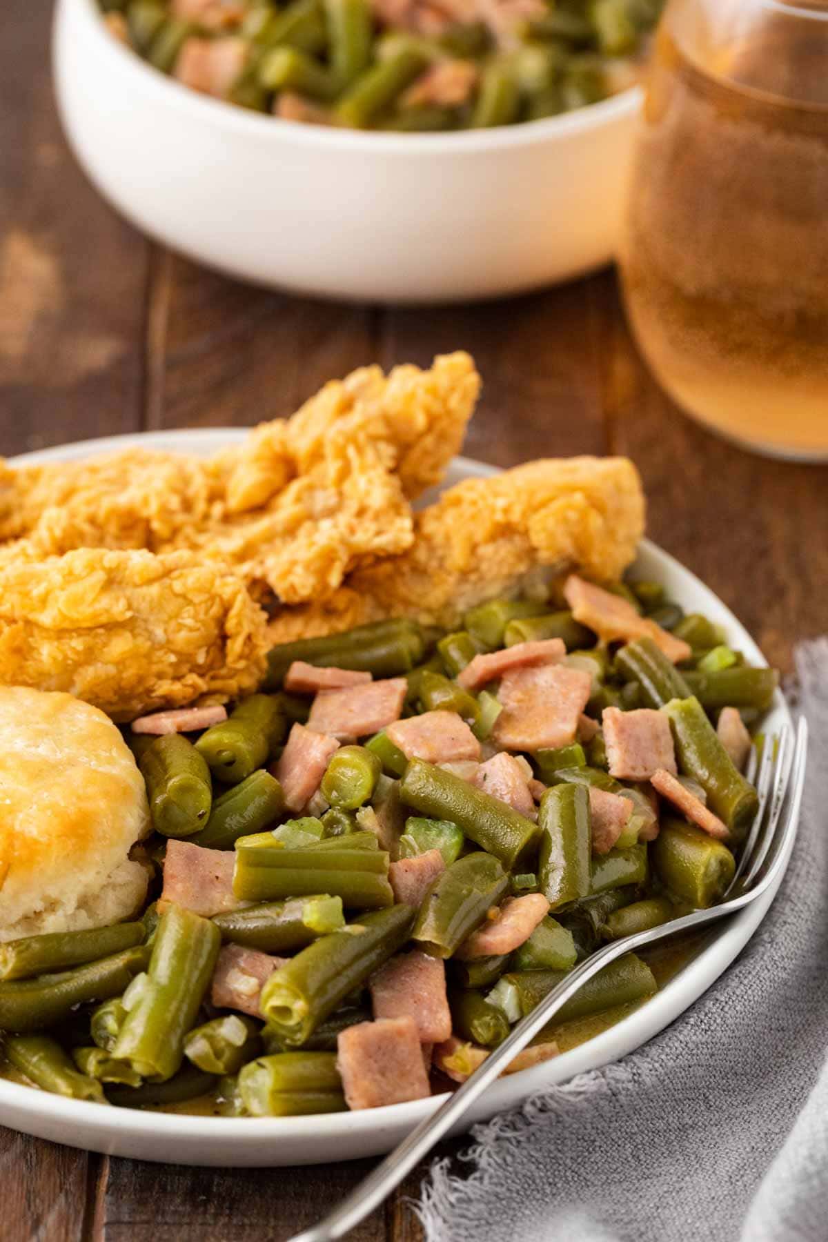 Popeye's Green Beans on plate with fried chicken and biscuit