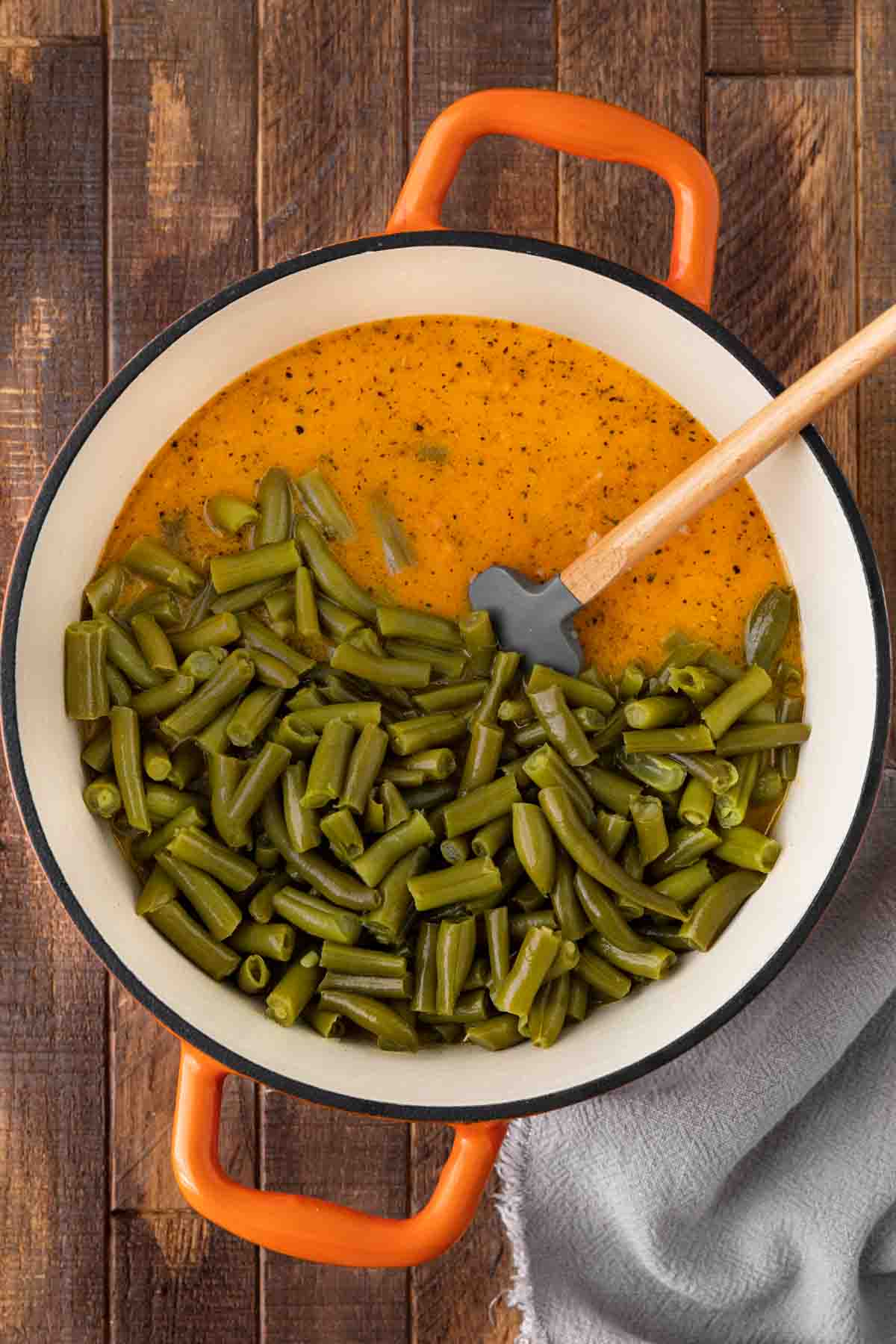 Popeye's Green Beans green beans added to gravy mixture in dutch oven