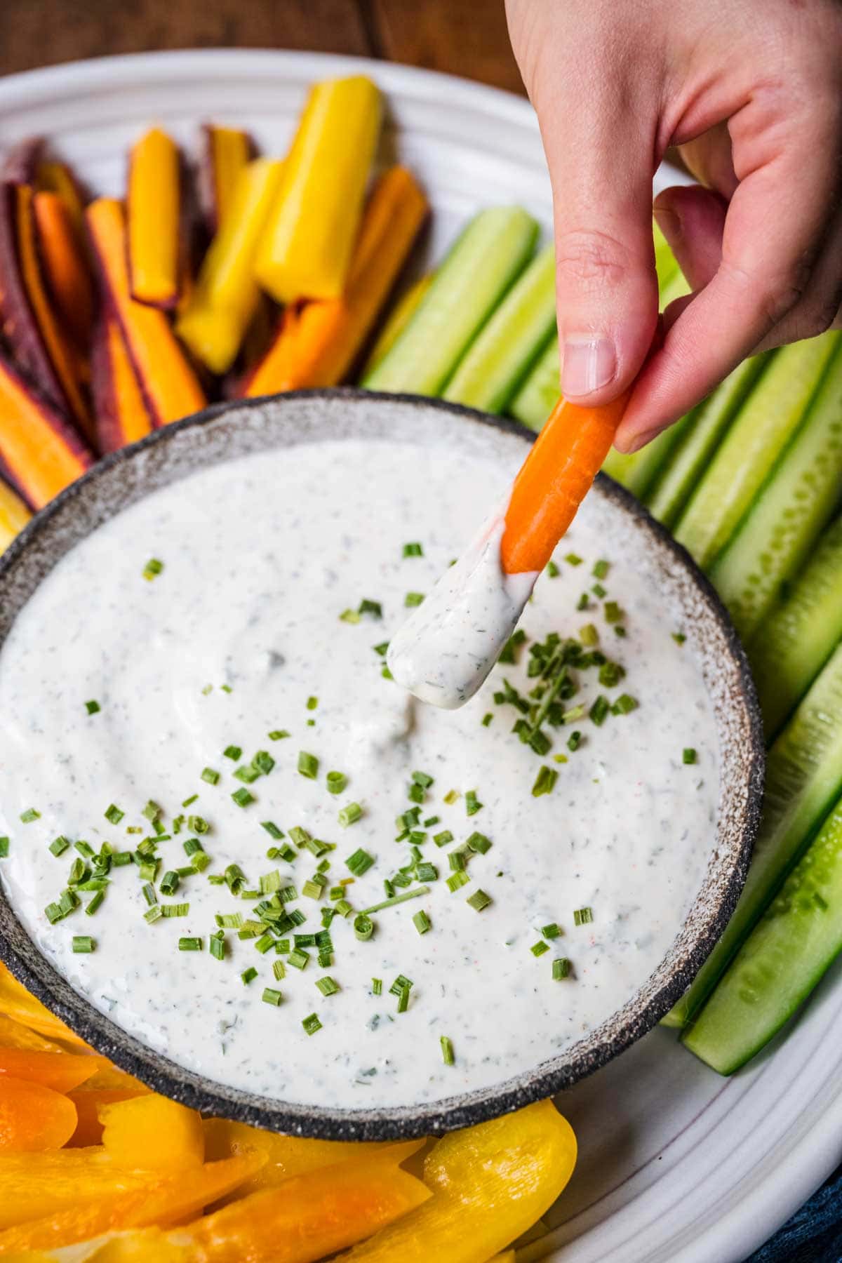 Ranch Dip in serving bowl with carrot being dipped