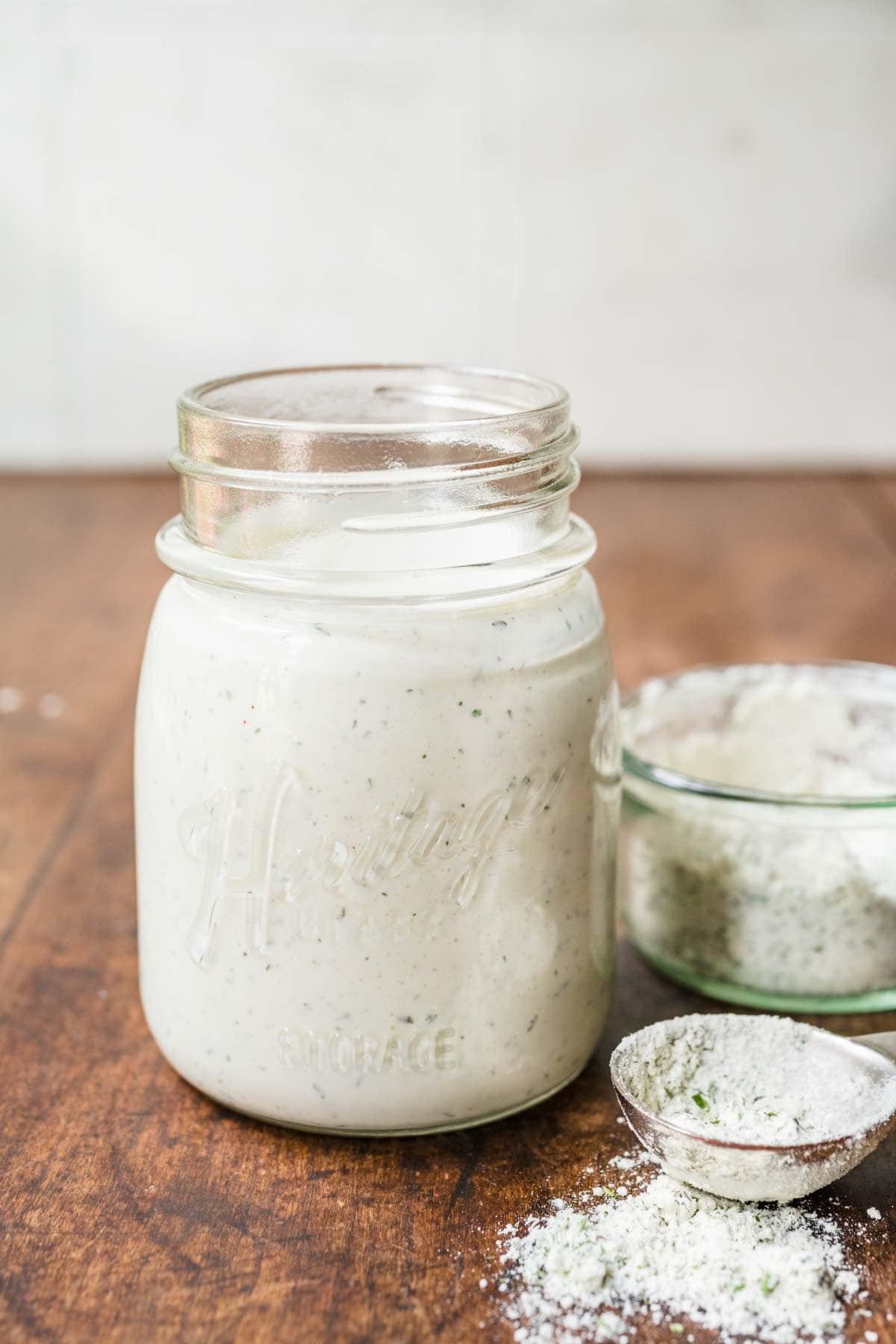 Dry Buttermilk Ranch Mix in mason jar with liquid and dry mix in bowl off to side