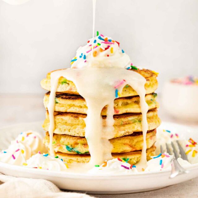 Birthday Cake Pancakes on plate with vanilla glaze
