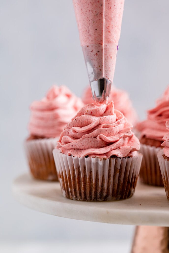 Strawberry Cupcakes being frosted