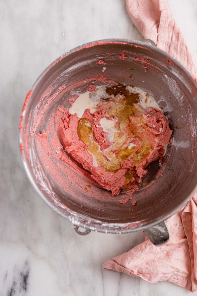 Strawberry Cupcake batter in mixing bowl half mixed