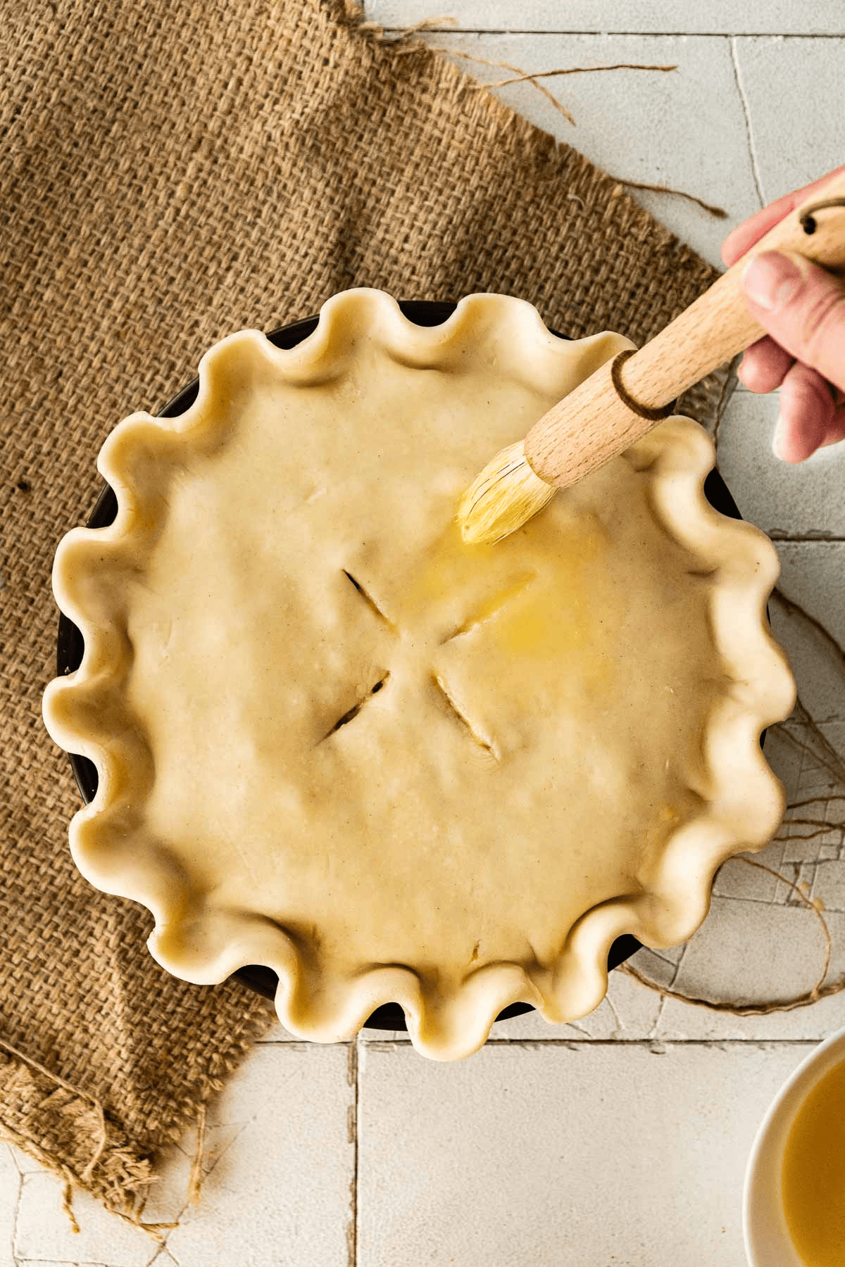 Brushing butter over a pie crust
