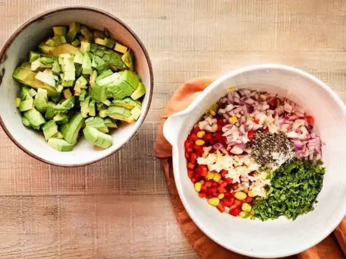 avocado in one bowl and other ingredients in another bowl