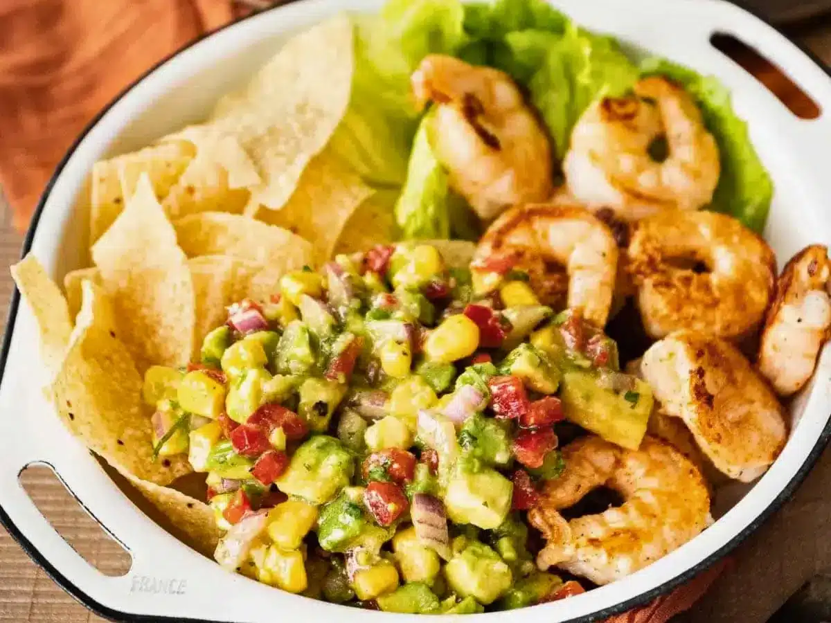 Bowl with shrimp, lettuce, tortilla chips. and salsa