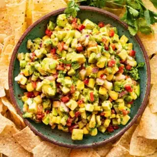 Tortilla chips surrounding bowl of salsa