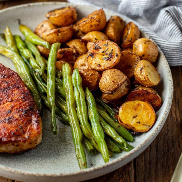 plate of chicken, green beens, and cooked potatoes